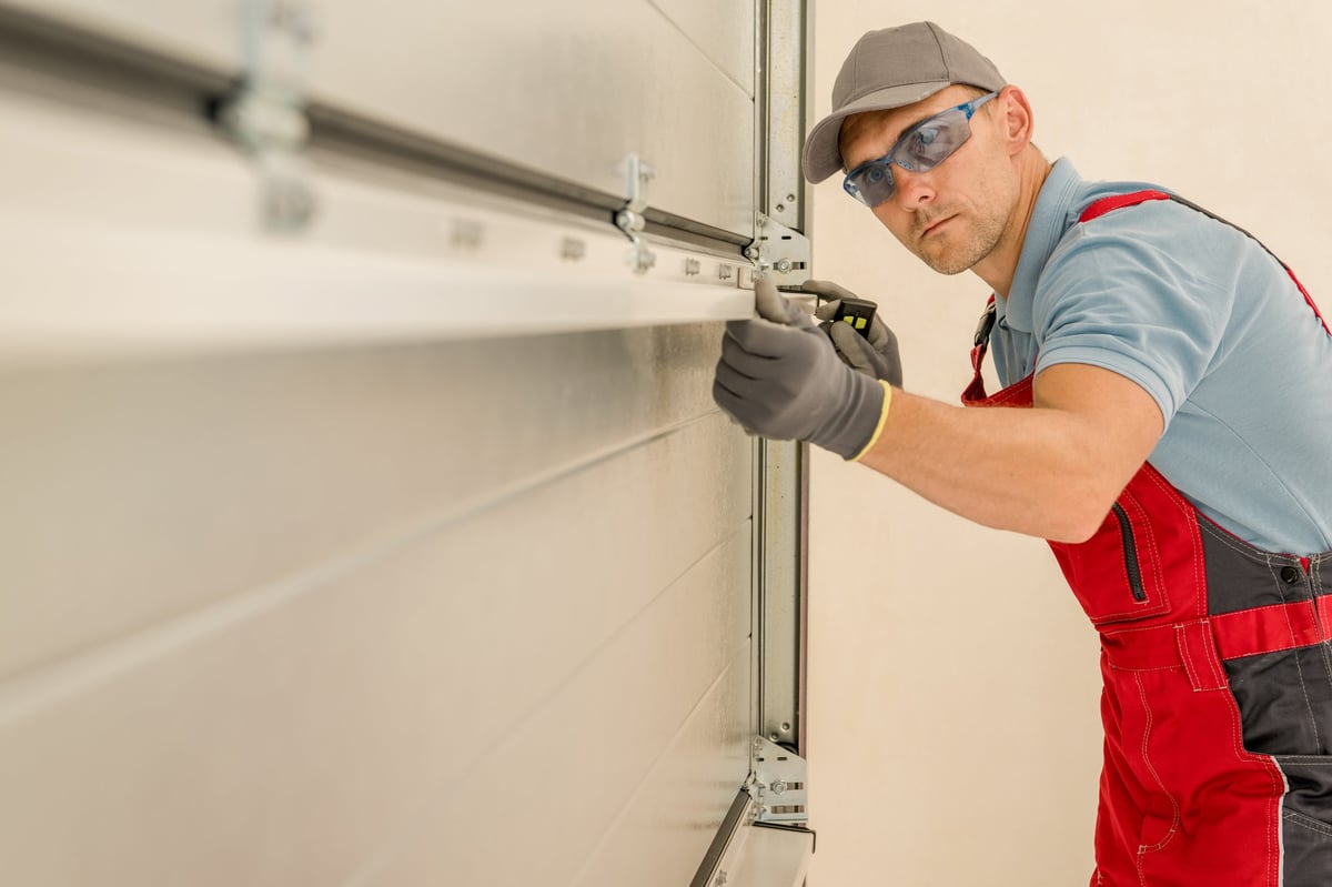 Professional technician installing a brand new residential garage door