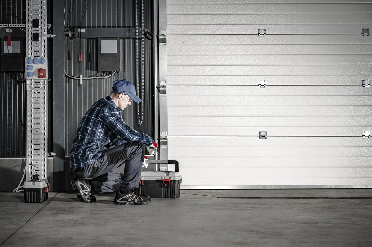 Experienced technician servicing a commercial garage door