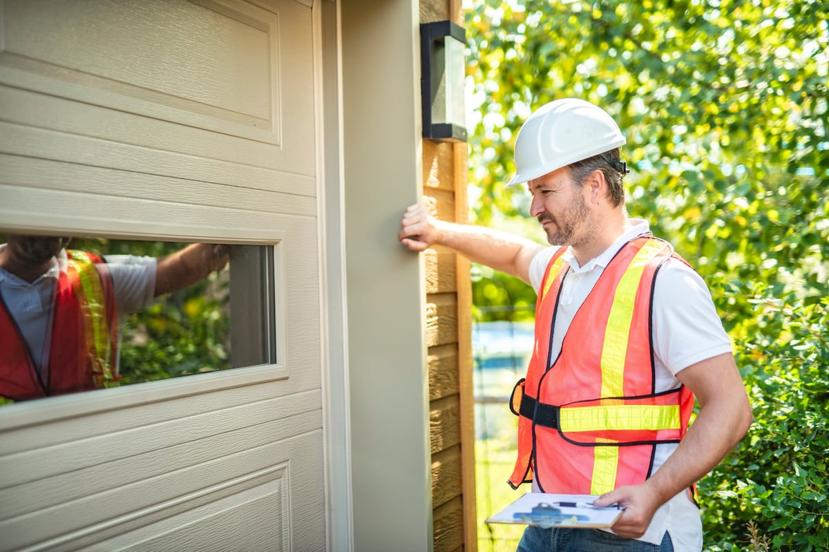 Technician fixing a garage door