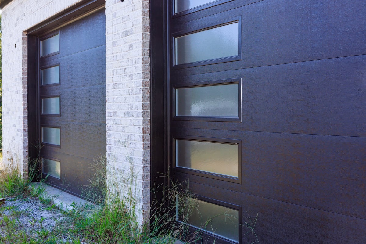 Modern dark garage door with glass panels