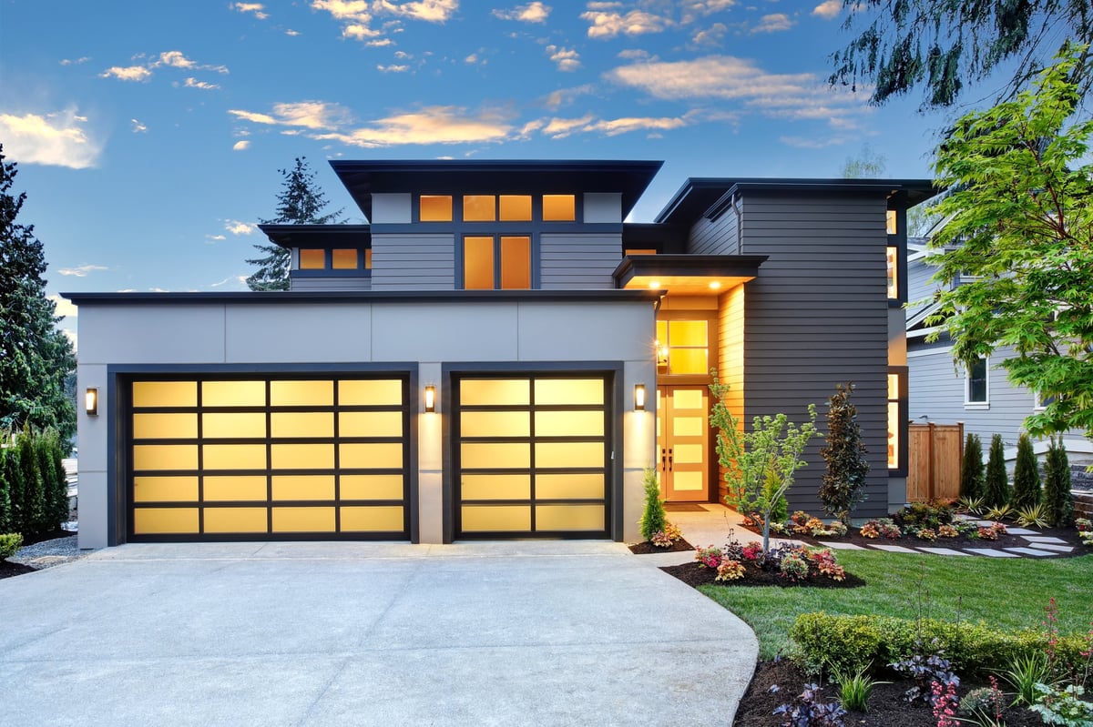 Contemporary home with two car garage at sunset